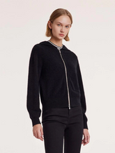 a lady in a black pure brushed cashmere hooded zippered cardigan with black jeans